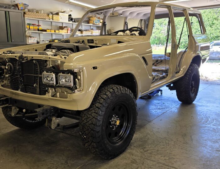 1988 Toyota Land Cruiser FJ62 V8 restomod in Desert Tan, driver side front view during restoration