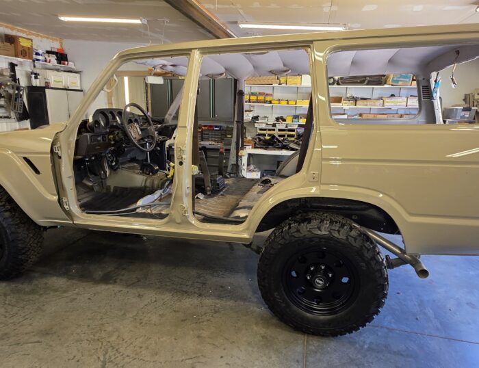 1988 FJ62 Land Cruiser V8 build, rear passenger side view in Desert Tan paint with custom rear bumper