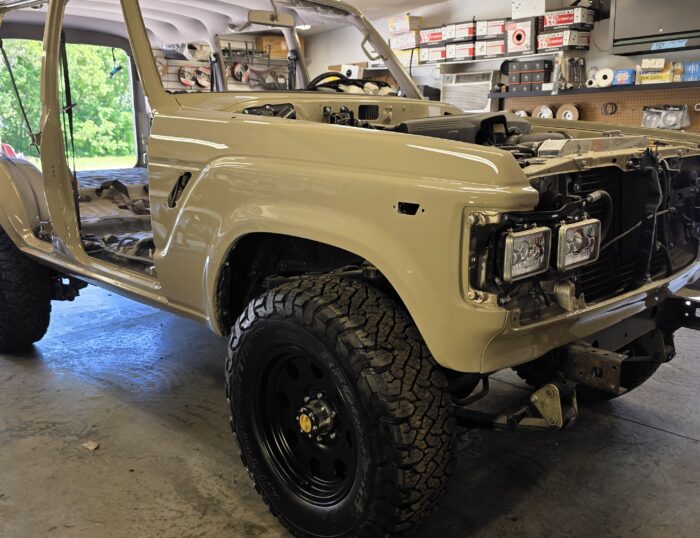 Restored 1988 FJ62 Land Cruiser V8 for sale, passenger side front view with new headlights, grille, and BFGoodrich tires
