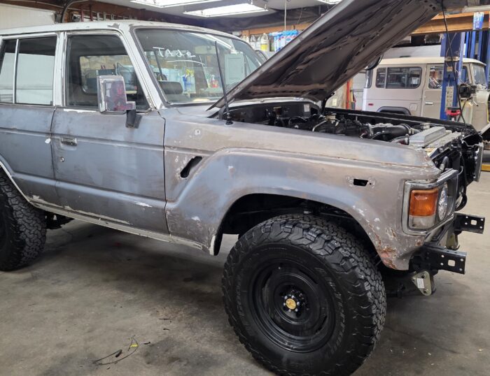 1987 Toyota Land Cruiser FJ60 with hood open at Land Cruiser Restorations in Belle Plaine, Kansas
