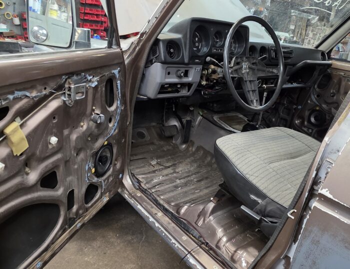1987 Toyota Land Cruiser FJ60 interior during restoration showing dash and steering wheel