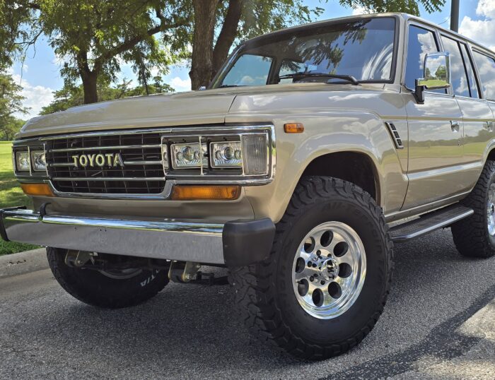Tan 1989 Toyota FJ62 Land Cruiser restomod with chrome bumper and polished wheels, restored by Land Cruiser Restorations