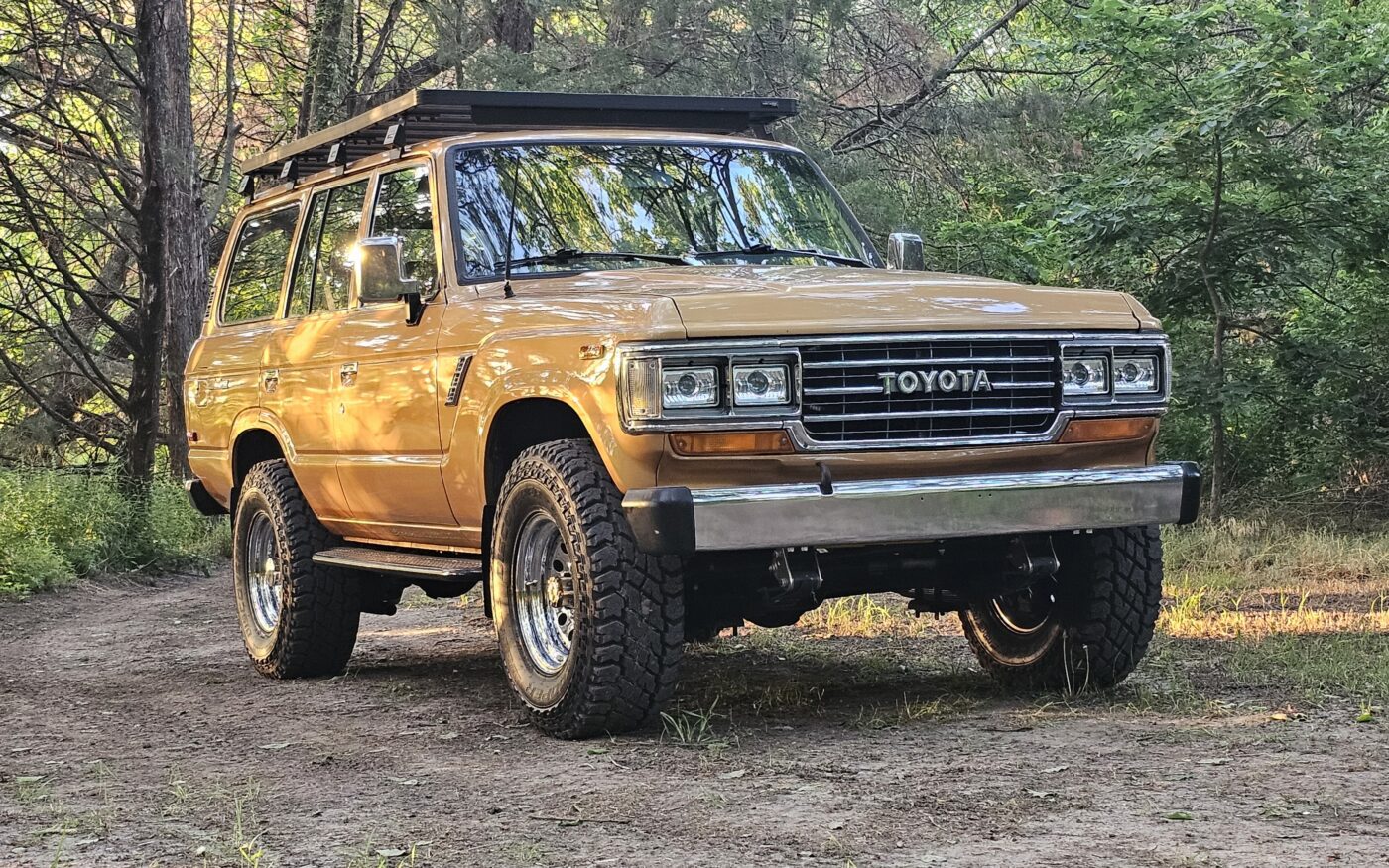 Custom Toyota Land Cruiser FJ60 in tan with roof rack, chrome bumper, and our custom accessories