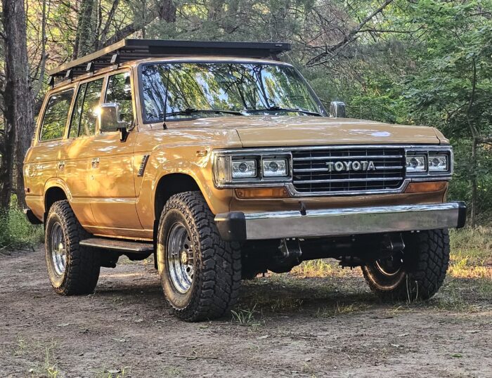 Custom Toyota Land Cruiser FJ60 in tan with roof rack, chrome bumper, and our custom accessories
