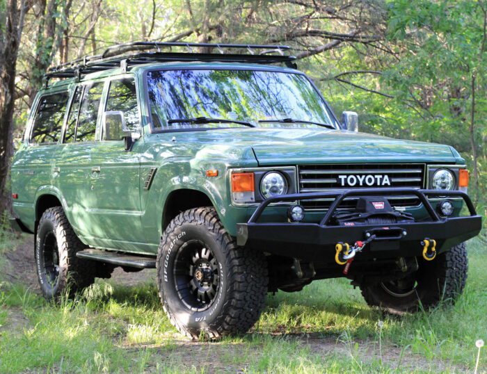 Velvet green 1989 Toyota FJ62 Land Cruiser restomod with black off-road bumper, Warn winch, and BFGoodrich tires, restored by Land Cruiser Restorations