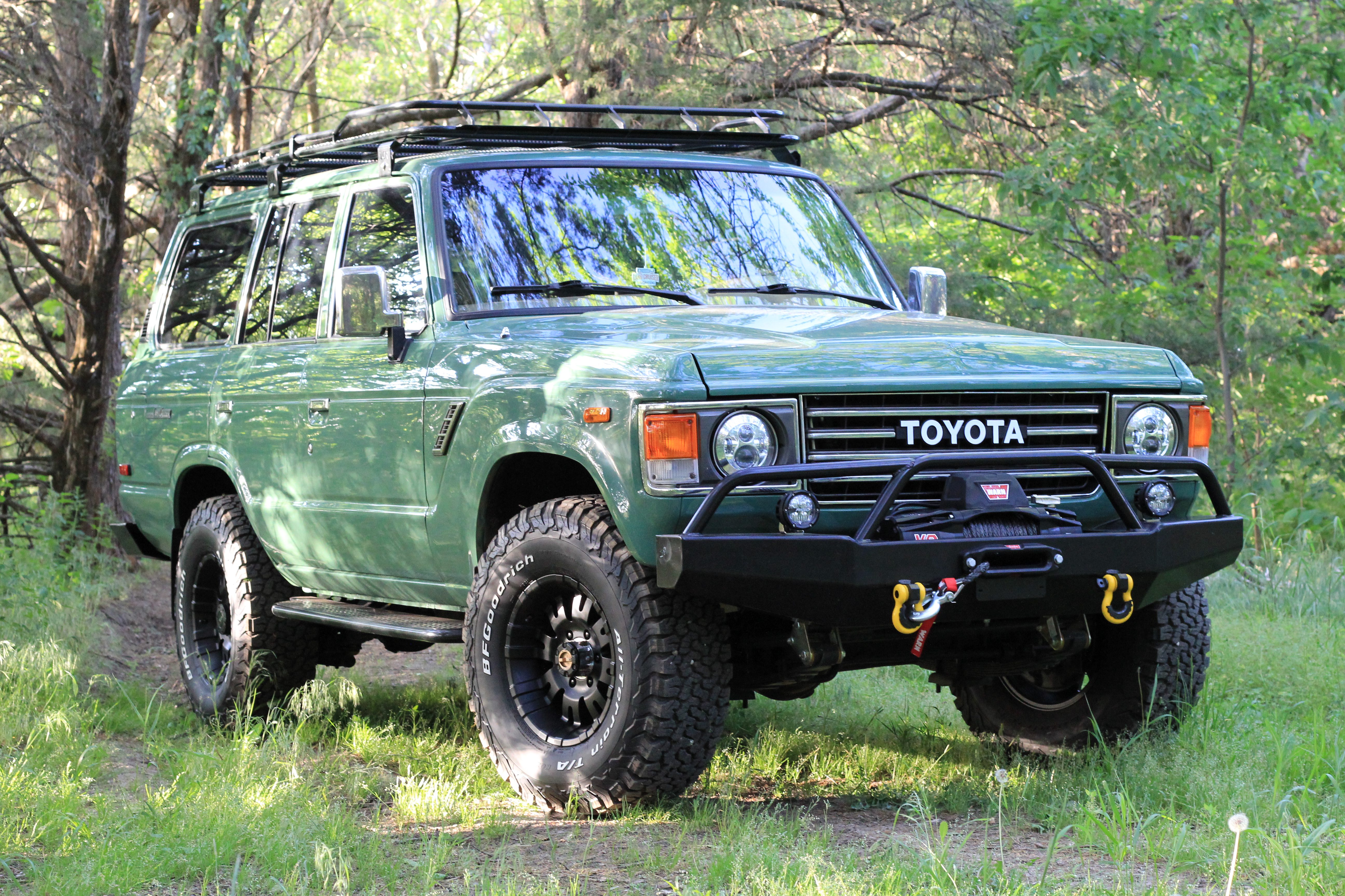 Velvet green 1989 Toyota FJ62 Land Cruiser restomod with black off-road bumper, Warn winch, and BFGoodrich tires, restored by Land Cruiser Restorations