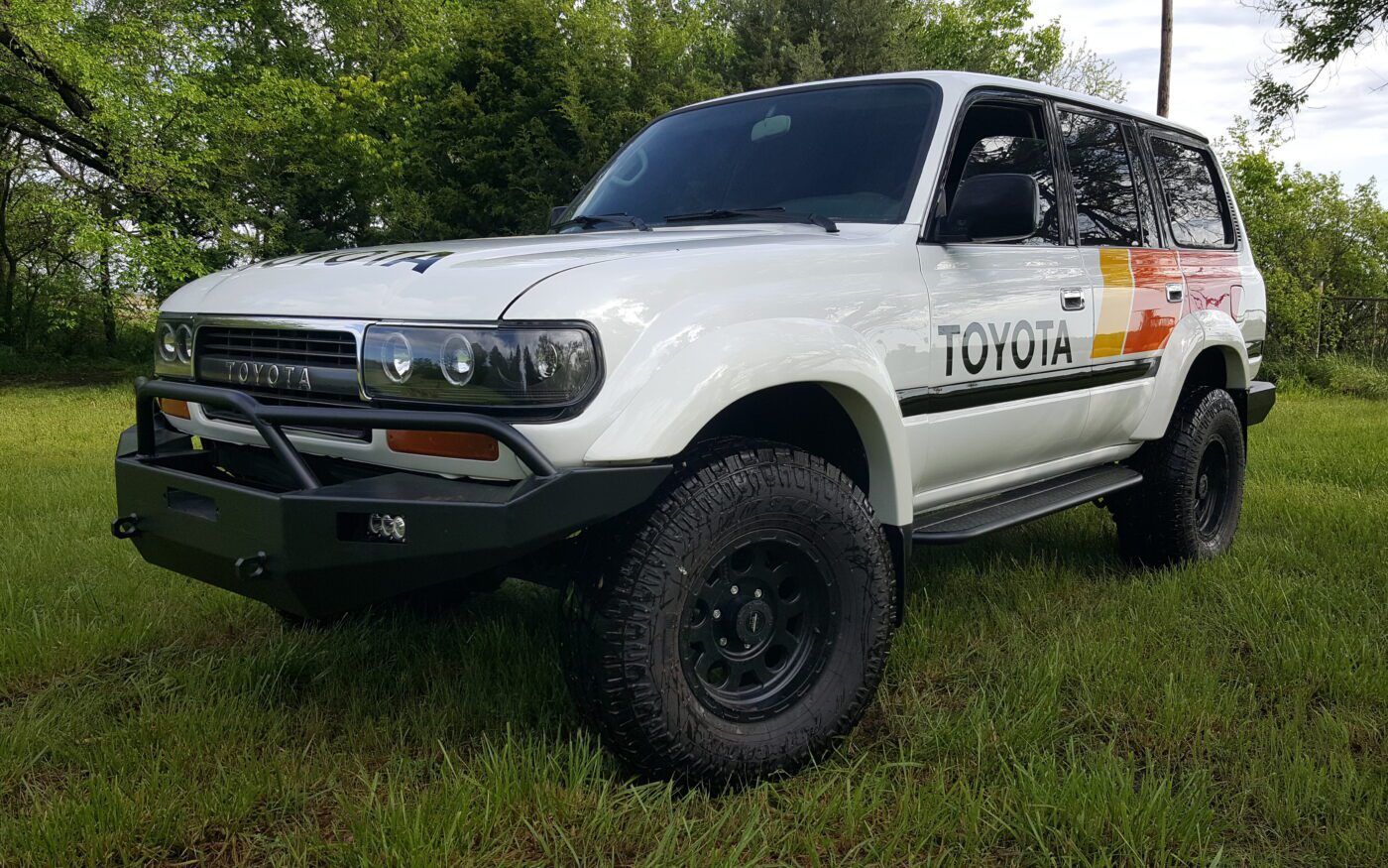 White Toyota 80 Series Land Cruiser with retro Toyota stripe livery and custom front bumper restored by Land Cruiser Restorations