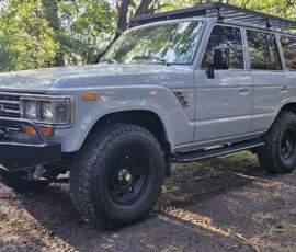 Custom Toyota Land Cruiser FJ60 in Destroyer Gray with roof rack, front winch bumper, and our custom accessories